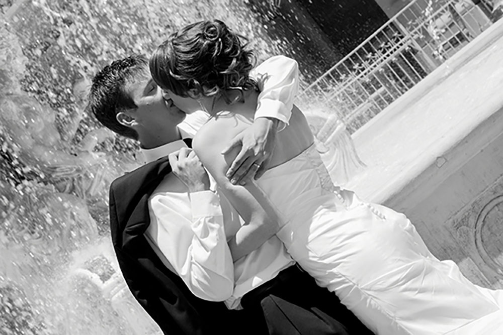 Wedding couple kissing near fountain at Paris Las Vegas