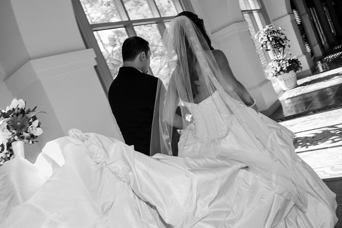 Luxury destination wedding bride and groom walking together in elegant black and white editorial style