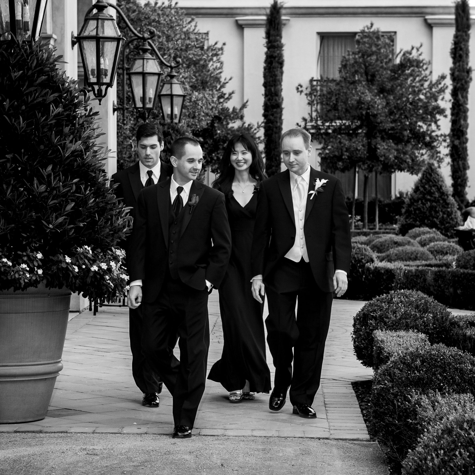 Groom and groomsmen walking through courtyard at Hilton Lake Las Vegas wedding