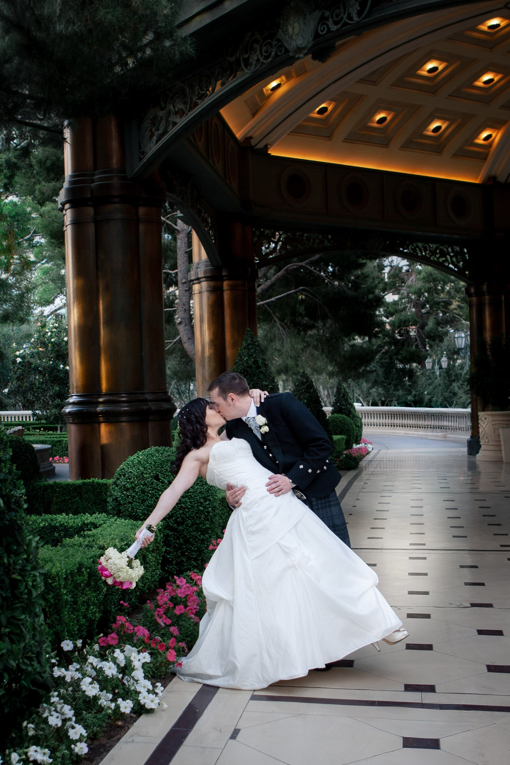 Bride and groom portrait beneath an illuminated pavilion at a luxury wedding venue