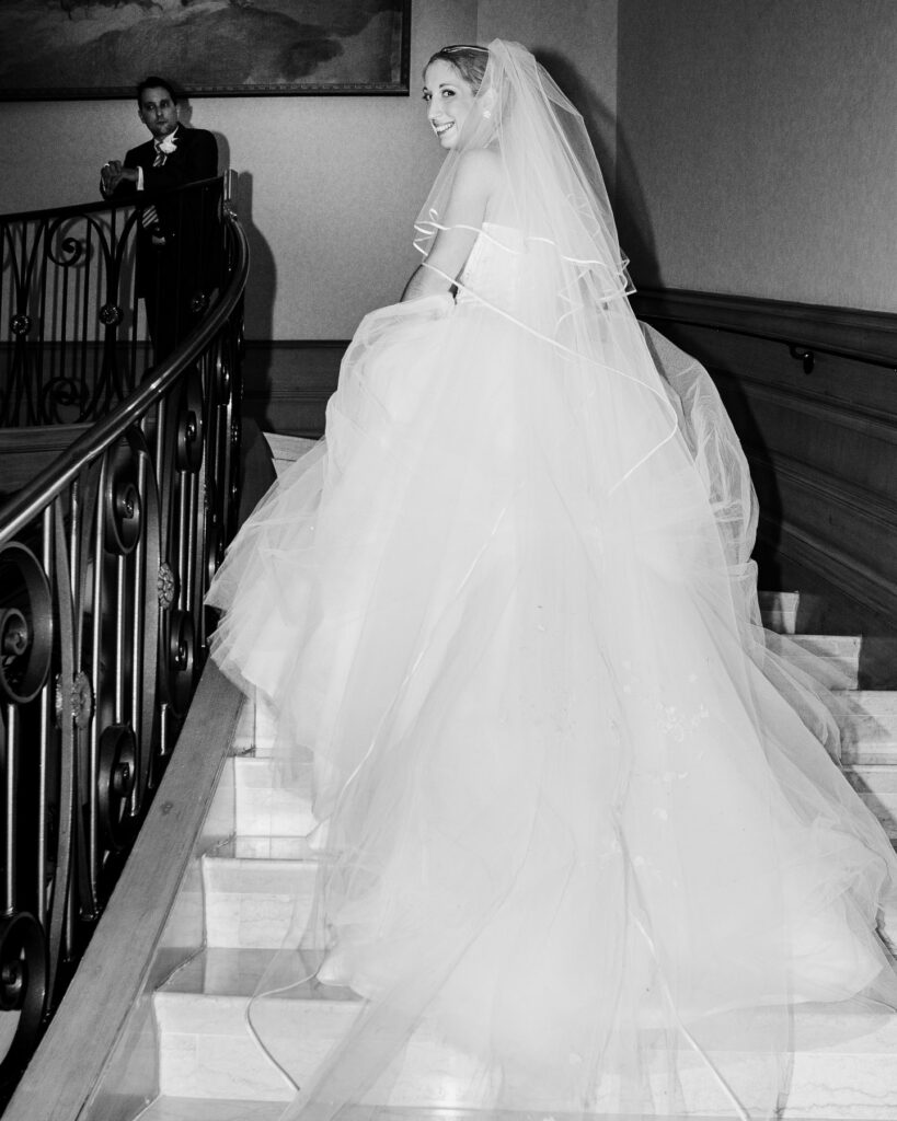 Bride walking up staircase at Napa Valley wedding captured in an editorial style by wedding photographer