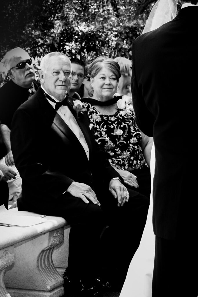 Father of the bride watching ceremony at Napa Valley wedding captured by editorial wedding photographer