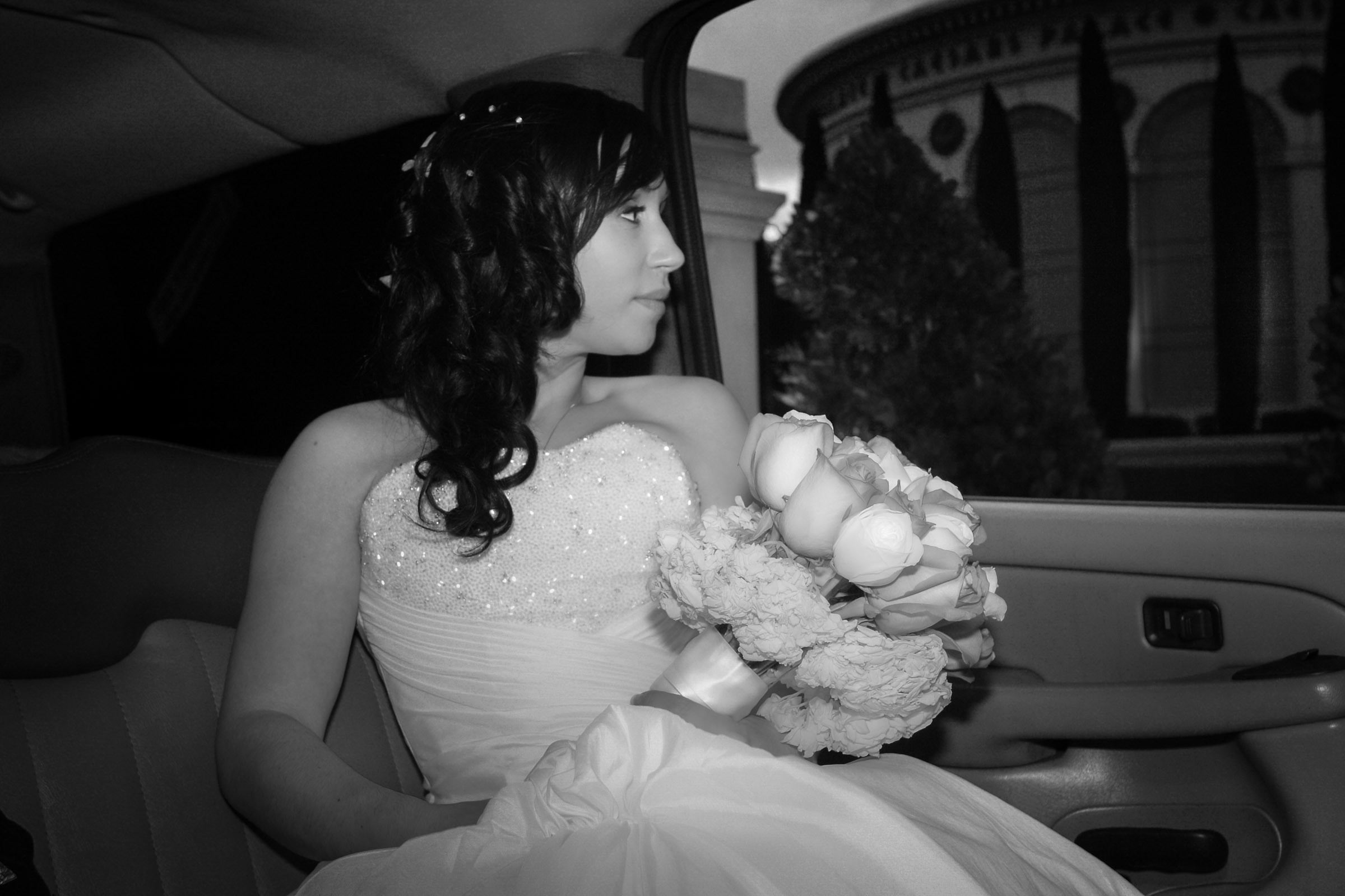 Las Vegas wedding photographer capturing bride in limo leaving Caesars Palace in a candid moment