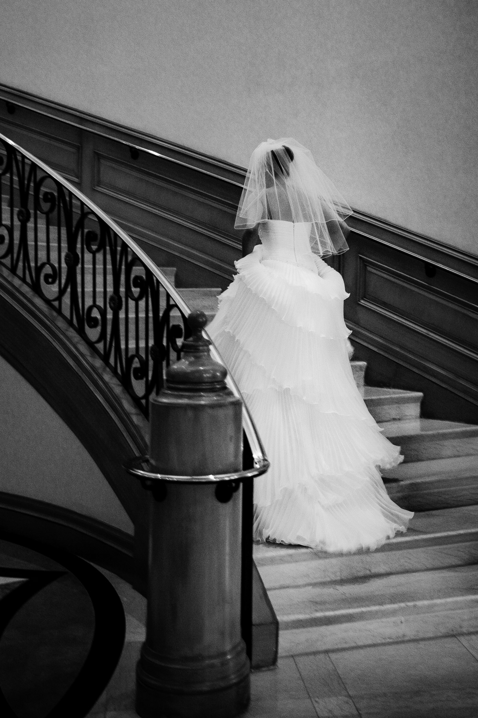 Bride walking up staircase at Four Seasons Hotel Las Vegas captured in a refined editorial wedding photography style