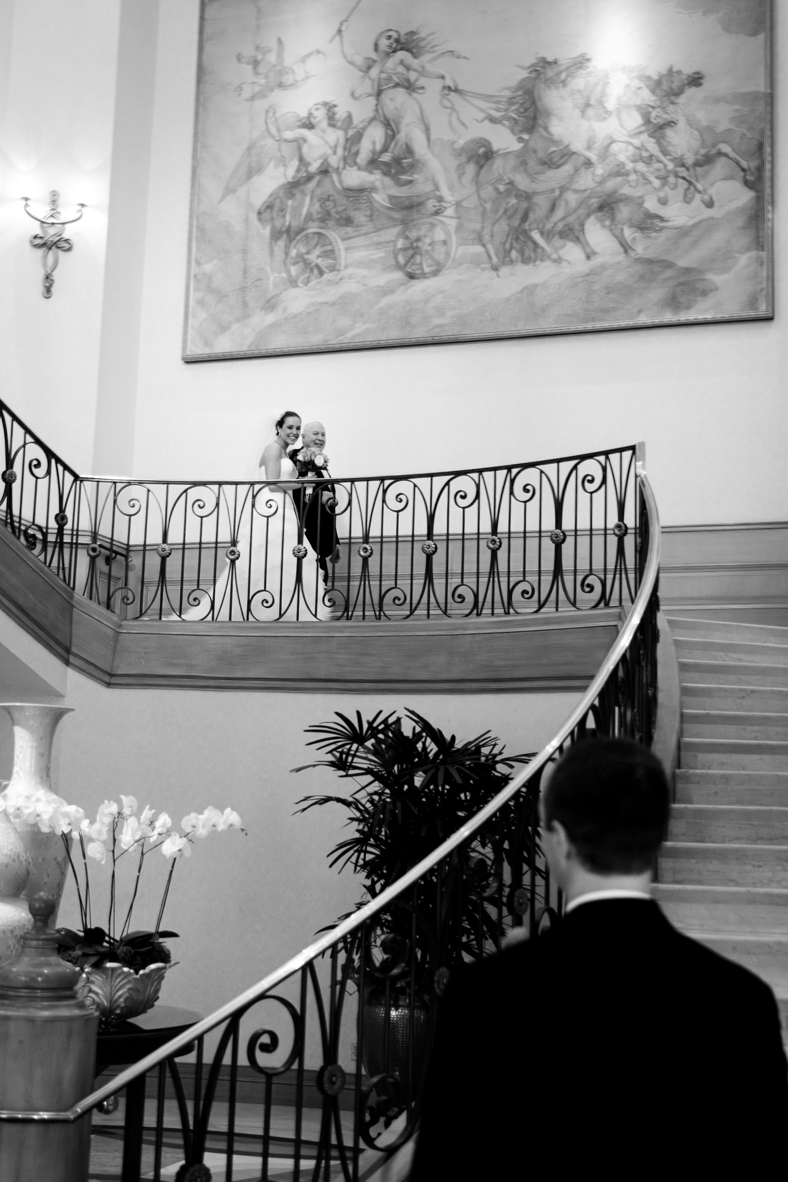 Bride with father above staircase before first look at Four Seasons Hotel Las Vegas captured in an editorial wedding photography style