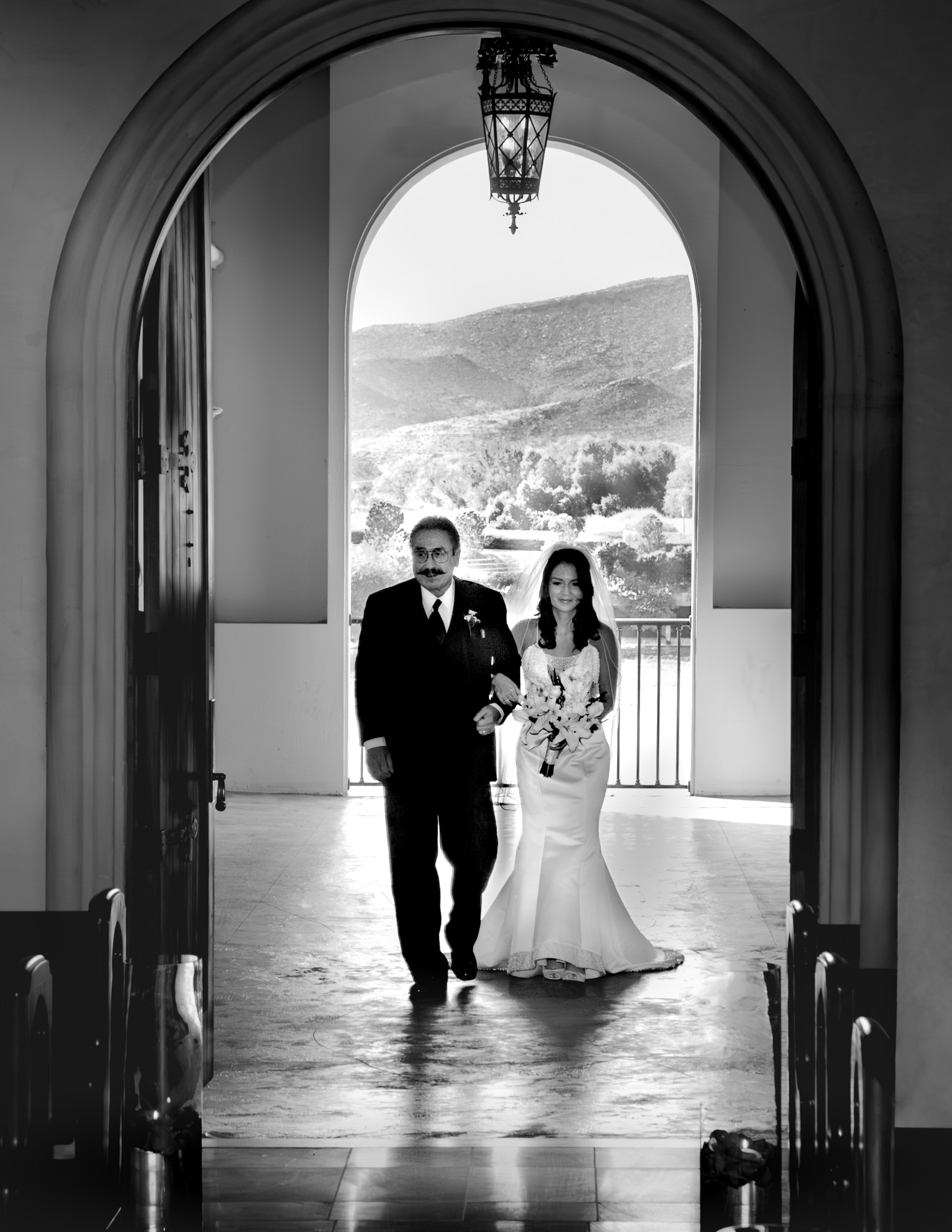 Father of the bride entering ceremony with lake and mountains in the background at Lake Las Vegas