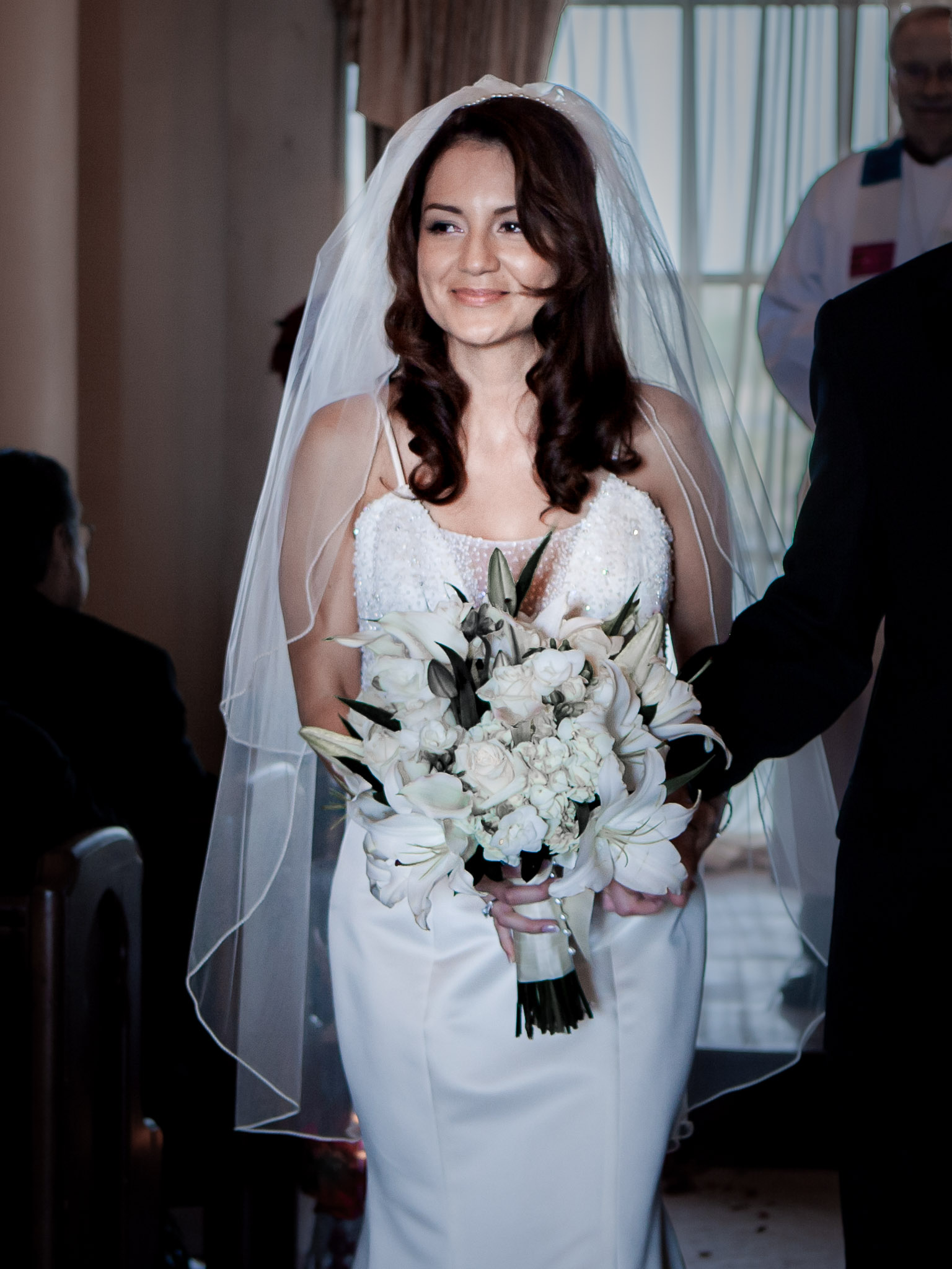 Confident bride entering private ceremony at Lake Las Vegas with bouquet and veil, luxury intimate wedding