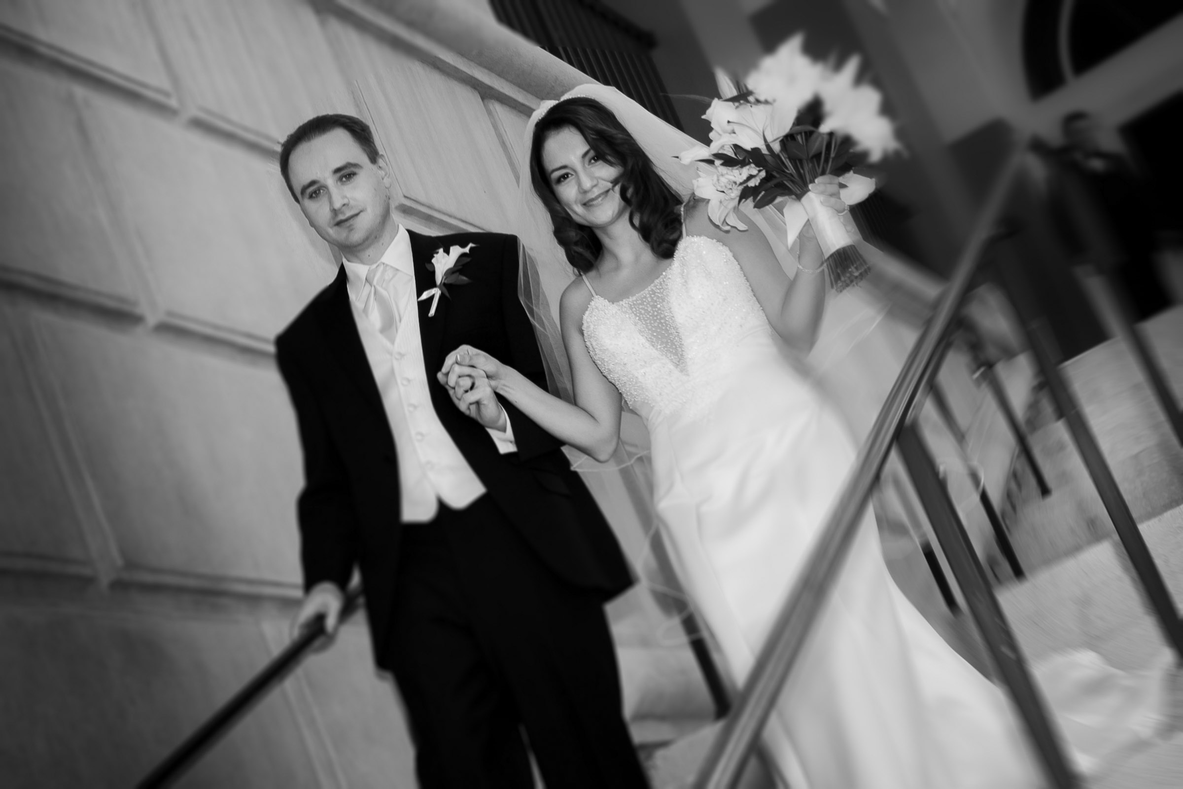 Bride and groom exiting ceremony on staircase at Lake Las Vegas with soft evening light