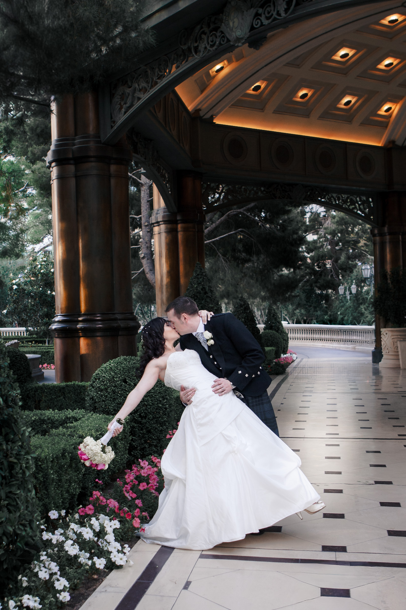 Las Vegas destination elopement couple under architectural canopy with cinematic editorial lighting