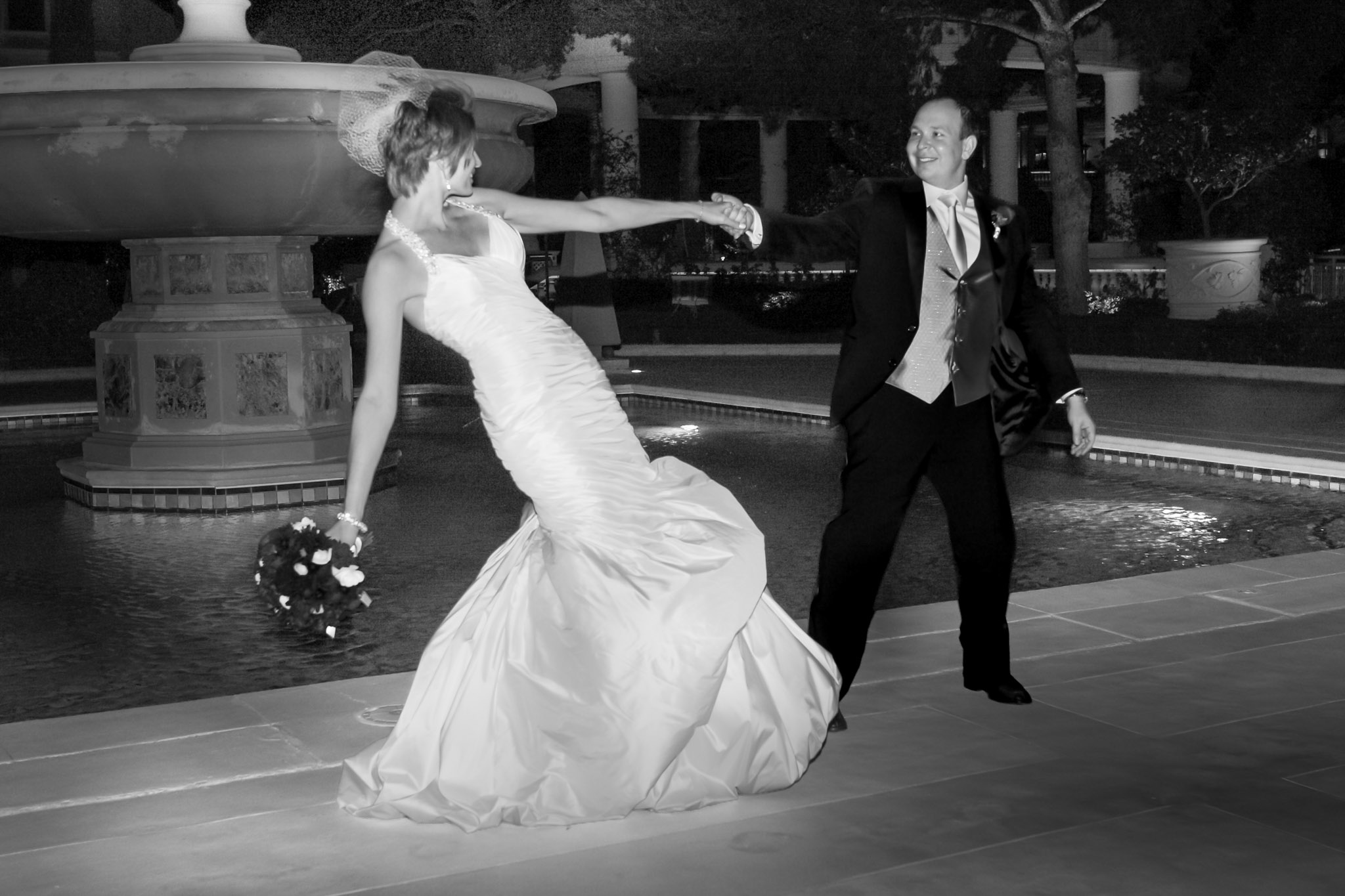 Las Vegas wedding photographer capturing cinematic motion of couple walking at Bellagio at night