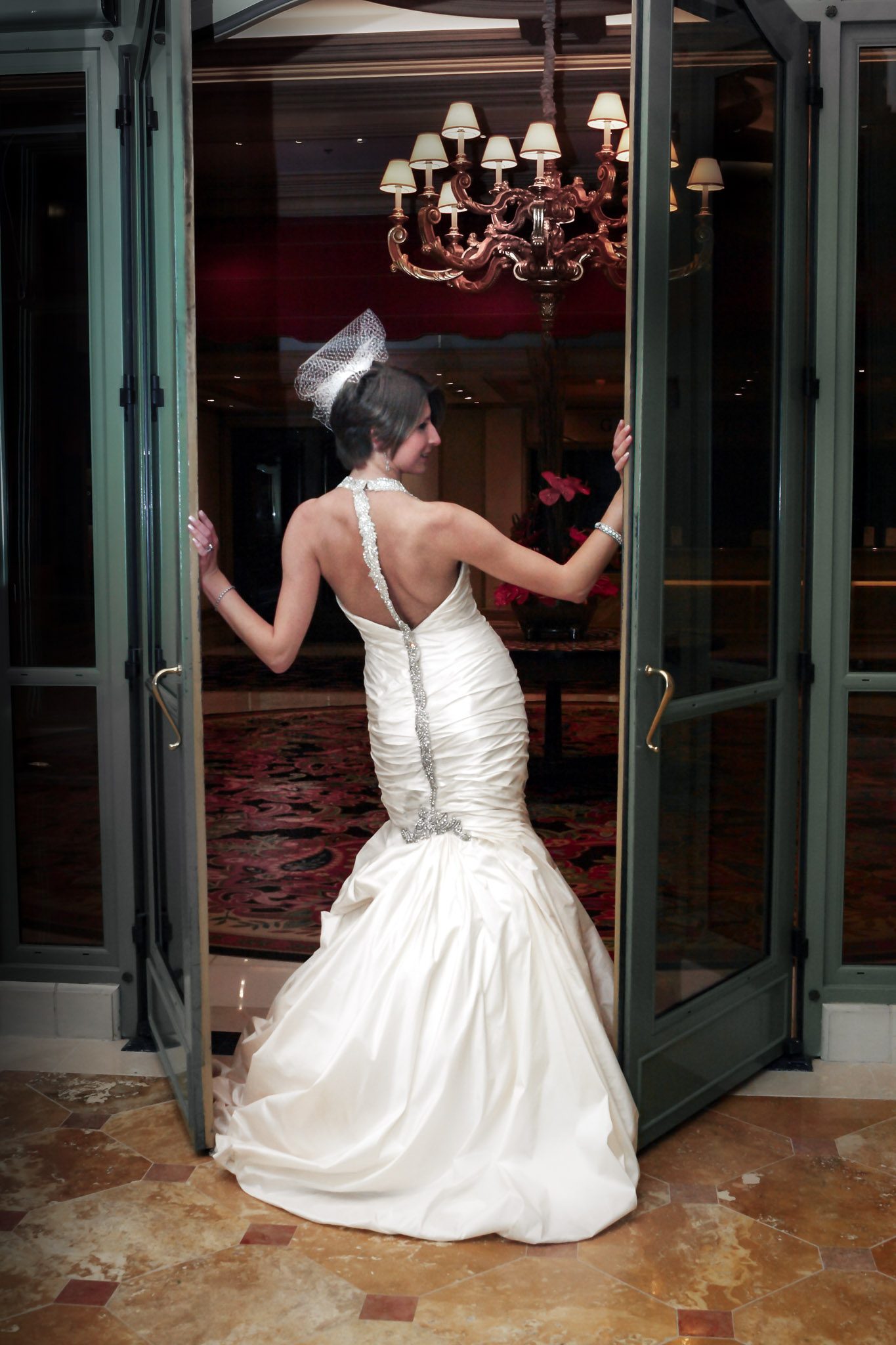 Las Vegas wedding photographer capturing bride entering Bellagio hotel for wedding ceremony