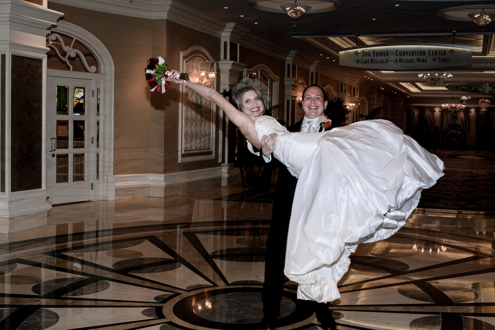 Las Vegas wedding photographer capturing joyful couple celebrating after wedding at Bellagio