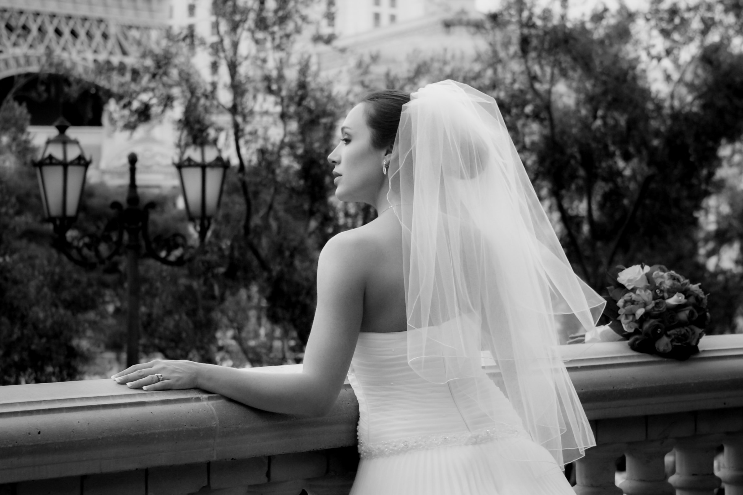 Las Vegas luxury wedding photographer capturing bride on Bellagio balcony in a candid, unscripted moment