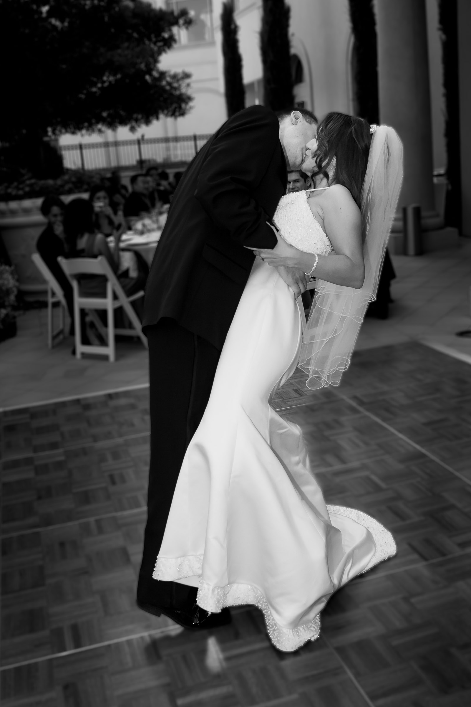 Couple kissing during reception at the Hilton Lake Las Vegas resort captured in a sophisticated candid editorial wedding photography style
