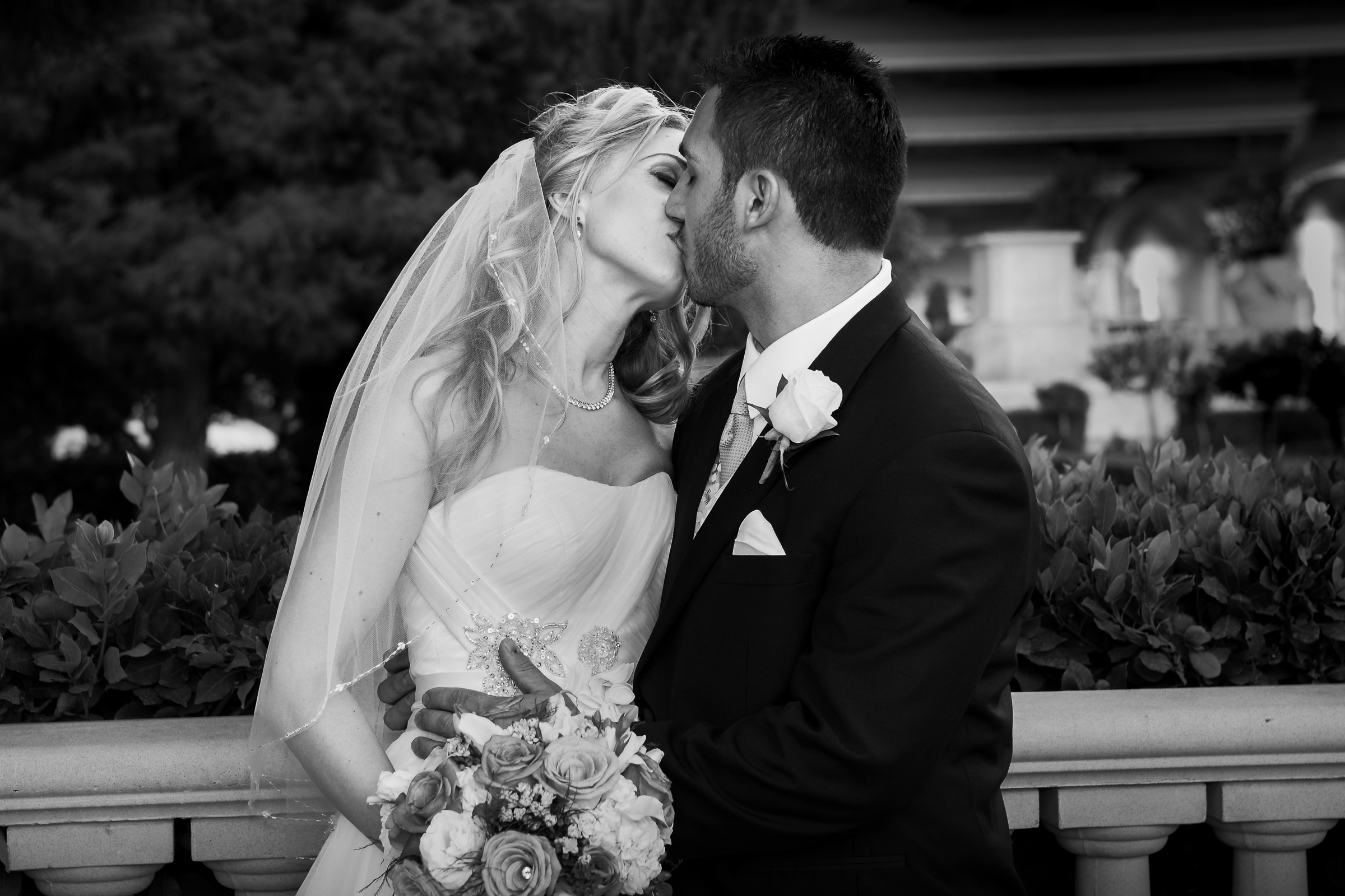 Luxury wedding photography outside of Caesars Palace in Las Vegas black and white kissing portrait