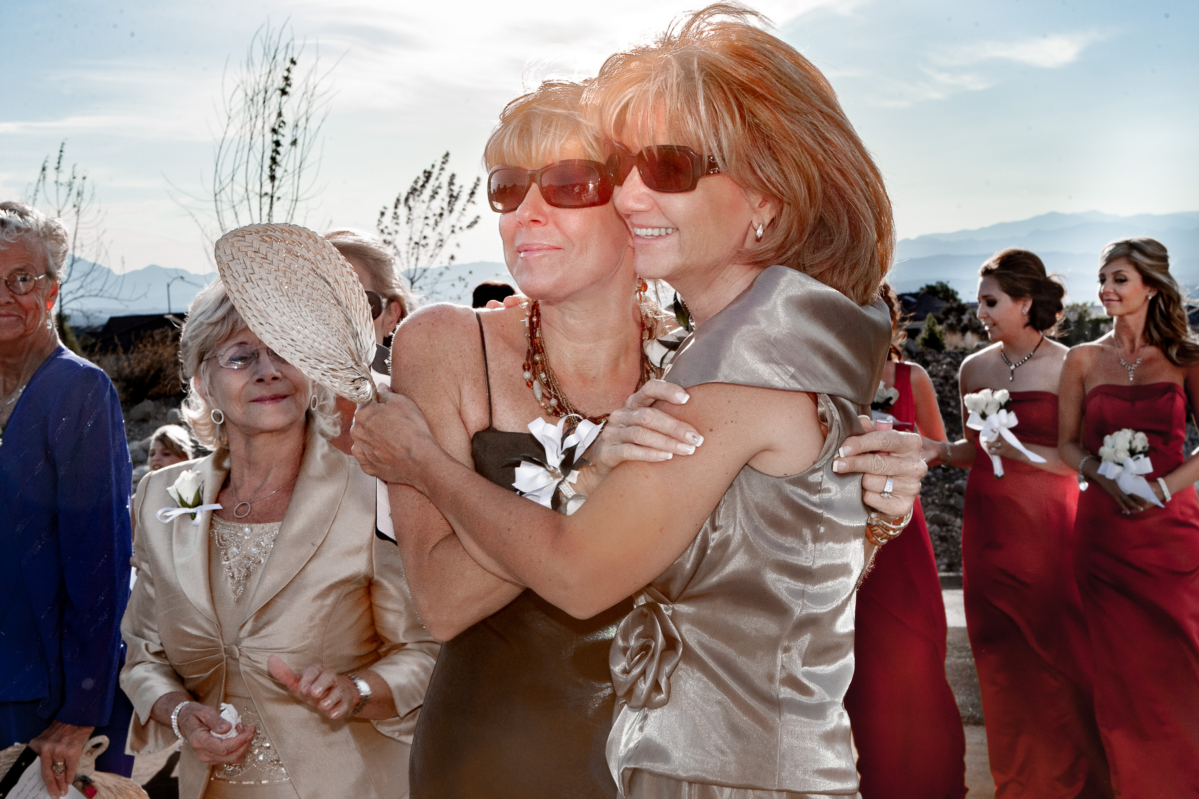 Mother of the bride and mother of the groom both wearing sunglasses at the ceremony