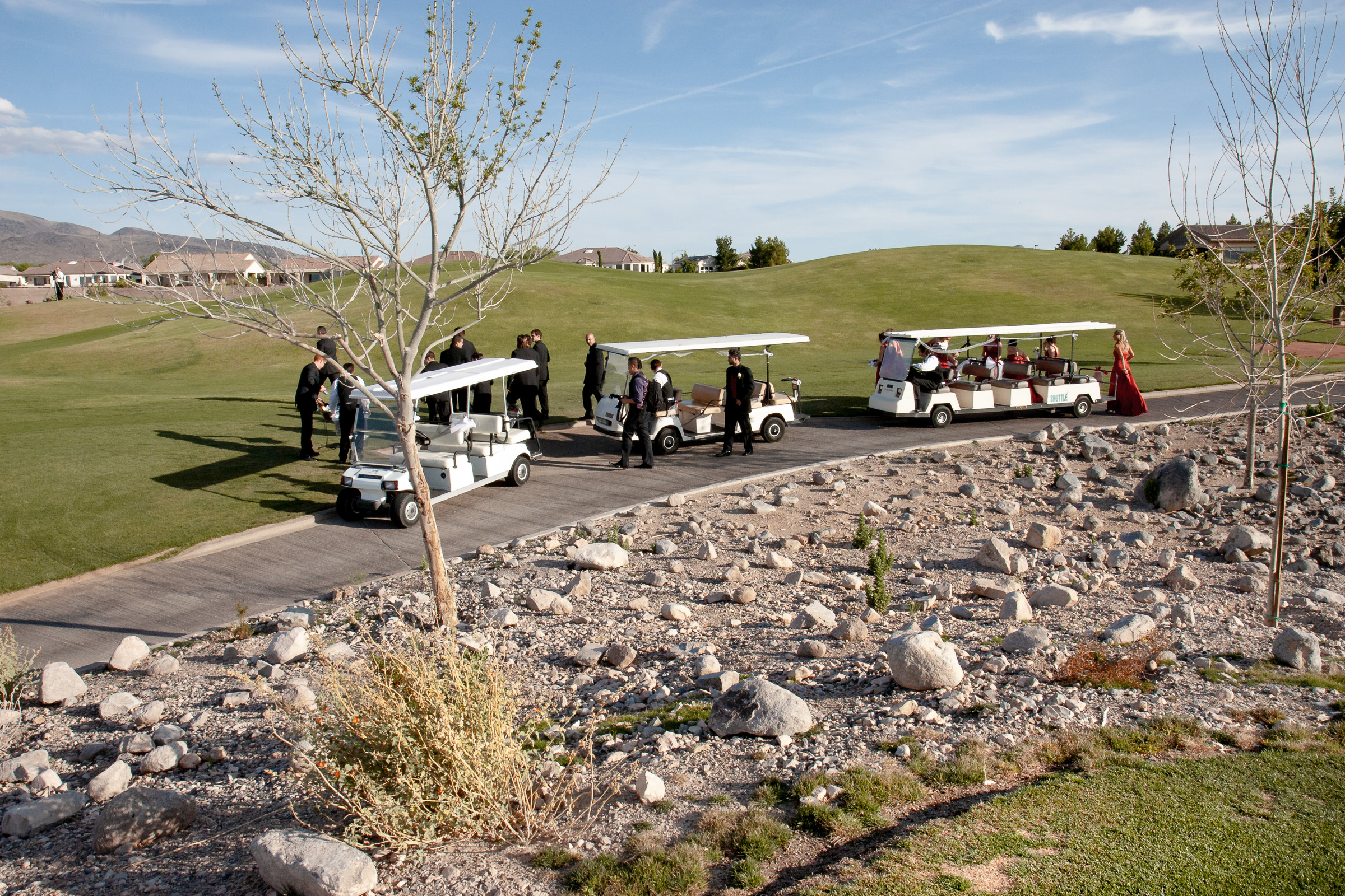 Bridal party being escorted to ceremony in golf carts