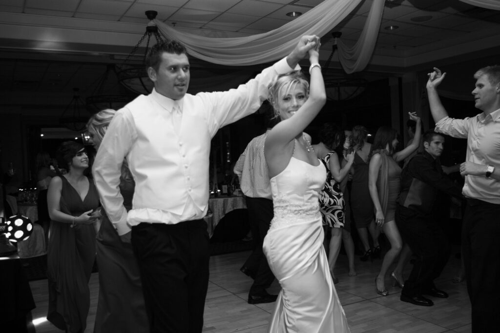 Black and white candid of bride and groom dancing
