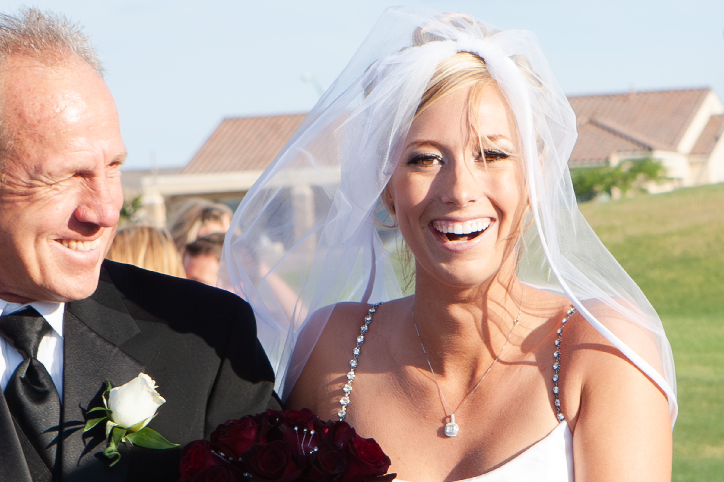 Closeup of bride walking up the isle with father at a golf course wedding